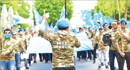  ?? EMMANUEL DUNAND/AFP ?? Ethnic Uighurs take part in a protest march on April 27 asking for the European Union to call upon China to respect human rights in the Chinese Xinjiang region and asking for the closure of ‘re-education center’ where some Uighurs are detained.