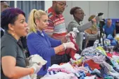  ?? SCOTT CLAUSE, THE (LAFAYETTE, LA.) DAILY ADVERTISER, VIA USA TODAY NETWORK ?? Volunteers help sort clothes at Houston’s George R. Brown Convention Center, which is being used as a shelter for Hurricane Harvey victims.