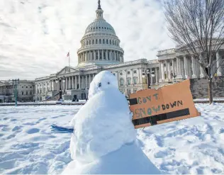  ?? J. Scott Applewhite / Associated Press ?? A snowman has a message for the Capitol on Monday as the partial government shutdown dragged into its 24th day. Polls show President Donald Trump is taking most of the blame from Americans.