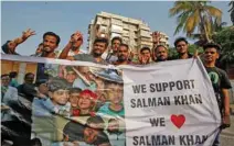  ?? - Reuters ?? ELATED: Fans of Bollywood actor Salman Khan pose as they hold a banner outside his house after a court in Jodhpur granted him bail, in Mumbai, India, April 7, 2018.