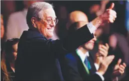  ?? Getty Images/tns ?? David H. Koch gives a thumbs-up to Herman Cain during the Defending the American Dream Summit at the Washington Convention Center in 2011. Koch, who along with his brother Charles ran Koch Industries for decades and became a household name in American politics, has died. Koch was 79.