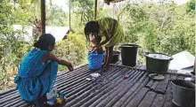  ?? New York Times News Service ?? A villager gives her son a bath in Mawlynnong. In this village in Meghalaya, every house has a toilet.