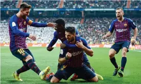  ??  ?? Luis Suárez is mobbed by his Barcelona teammates after after scoring his team’s opener against Real Madrid. Photograph: Quality Sport Images/Getty Images