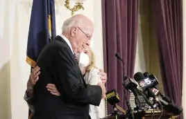  ?? MARY SCHWALM AP ?? Sen. Patrick Leahy, D-Vt., hugs his wife, Marcelle Pomerleau, on Monday at the Vermont State House in Montpelier after announcing he will not seek reelection. Leahy is 81.