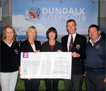  ??  ?? Geraldine Minogue accepts €3,000 on behalf of The Rape Crisis North Branch from Dundalk Golf Club.