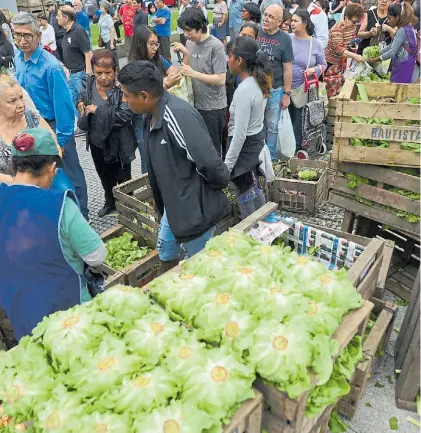  ?? LUCIANO THIEBERGER ?? Costo de vida. Vecinos hacen fila en una feria para hacerse de verduras más accesibles.