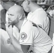  ?? Karen Warren / Houston Chronicle ?? Astros catcher Brian McCann takes in Monday’s game from the dugout while on the seven-day disabled list due to a concussion.