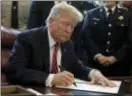  ?? EVAN VUCCI — THE ASSOCIATED PRESS ?? President Donald Trump signs the first veto of his presidency in the Oval Office of the White House, Friday in Washington. Trump issued the first veto, overruling Congress to protect his emergency declaratio­n for border wall funding.