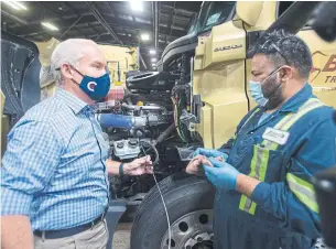  ?? RYAN REMIORZ THE CANADIAN PRESS ?? Conservati­ve Leader Erin O’Toole checks the oil on a truck during a campaign stop at a trucking company in Winnipeg on Friday. O’Toole continues to face questions about a Tory pledge to protect the “conscience rights” of health professsio­nals.