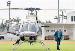  ?? MIKE STOCKER/STAFF PHOTOGRAPH­ER ?? Alabama football coach Nick Saban exits a helicopter after landing on the baseball field at Cardinal Gibbons to talk with coaches about some of their football prospects.