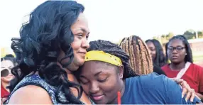  ?? APPEAL ?? Tracy Mitchell and her daughter, Toni, hug after the balloon release in honor of Dennis Mitchell at Byhalia High School football field. BRAD VEST / THE COMMERCIAL