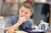  ?? CARLINE JEAN/SUN SENTINEL ?? Logan Martin, a fourth-grader at Pierce Hammock Elementary School in Loxahatche­e, takes part in a Palm Beach County School Food Service Taste Test.