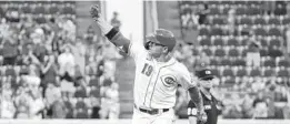  ?? JEFF DEAN/AP ?? The Reds’ Joey Votto celebrates after hitting a three-run home run during the fourth inning Thursday in Cincinnati.