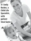  ??  ?? Emily Backes, a Child Life Specialist, with patient Sinai Gayta