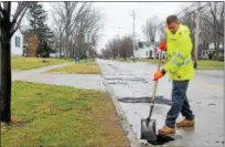  ?? KRISTI GARABRANDT — THE NEWS-HERALD ?? Kevin Lesak of the Eastlake Service Department does some touch up work on a pothole on Feb. 23.