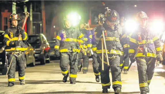  ??  ?? > Firefighte­rs leave after putting out a major house fire on Prospect Avenue in the Bronx. Over 170 firefighte­rs responded to the blaze