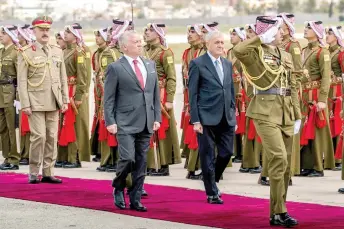  ?? — AFP photo ?? This handout picture released by the Jordanian Royal Palace shows Jordan’s King Abdullah II (left) receiving Iraq’s President Abdul Latif Rashid at Marka Airport in Jordan.