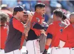  ?? RON SCHWANE/AP ?? Guardians second baseman Andres Gimenez celebrates with teammates after hitting a game-winning home run against the Twins on Thursday.