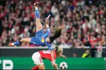  ?? (AP) ?? Benfica’s Lucia Alves, bottom, challenges for the ball with Lyon’s Selma Bacha during the women’s Champions League quarterfin­als, first leg, soccer match between SL Benfica and Olympique Lyonnais at the Luz Sta
dium, in Lisbon, Tuesday, March 19, 2024.