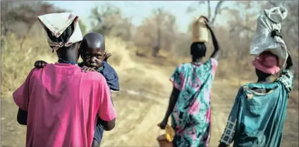  ?? PICTURE: AP ?? People walk for hours to reach a food distributi­on site in Malualkuel, in the Northern Bahr el Ghazal region of South Sudan. Two months after a famine was declared in two counties amid civil war, hunger has become more widespread than expected, aid...