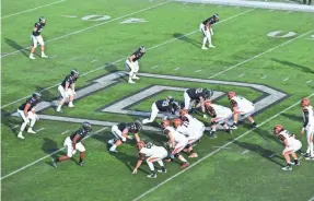  ?? AKI SOGA, BURLINGTON (VT.) FREE PRESS ?? Dartmouth players, left, line up against Princeton on Nov. 21 during the Big Green’s 17-10 victory, which clinched a share of last year’s Ivy league title.