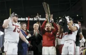  ?? DAVID J. PHILLIP - THE ASSOCIATED PRESS ?? Alabama head coach Nick Saban holds up the championsh­ip trophy after overtime of the NCAA college football playoff championsh­ip game against Georgia, Monday.