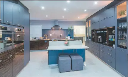  ??  ?? The kitchen is modern and spacious, and perfect for the entertaine­r.