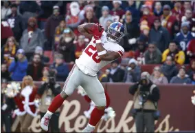  ?? ALEX BRANDON - THE ASSOCIATED PRESS ?? New York Giants running back Saquon Barkley catches a touchdown pass from quarterbac­k Daniel Jones during the first half of an NFL football game against the Washington Redskins, Sunday, Dec. 22, 2019, in Landover, Md.