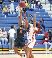  ?? [PHOTO BY SARAH PHIPPS, THE OKLAHOMAN] ?? Douglass’s Ashari Sykes goes to the basket as John Marshall’s Asian Henry defends during Tuesday’s girls basketball game at John Marshall High School in Oklahoma City.