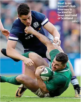  ??  ?? Heat is on: Ireland’s Rob Kearney is tackled by Sean Maitland of Scotland