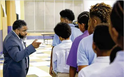  ?? TY GREENLEES / STAFF ?? Dayton Boys Prep Academy Principal Therman Sampson II directs students to the cafeteria for breakfast on the first day of school.