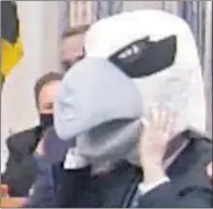  ?? SCREENSHOT BY MARTY MADDEN ?? Calvert County Commission­er Mike Hart (R) tries on the osprey mascot’s head to promote the April 2 Maryland Osprey and Nature Festival at Drum Point club.