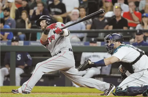  ?? AP FILE PHOTO ?? TAKE TWO: Dustin Pedroia connects for a two-run double during the sixth inning against the Mariners last night in Seattle. Pedroia’s double capped a rally from an early three-run deficit, which also included a solo home run by Hanley Ramirez (below),...
