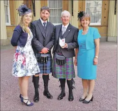  ??  ?? Jenna, Martin, Howard and Lesley Wood are pictured outside Buckingham Palace after Howard received his OBE.