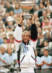  ?? REMY DE LA MAUVINIERE — THE ASSOCIATED PRESS FILE ?? In this file photo, Austria’s Thomas Muster raises the trophy after wining the men’s final of the French Open tennis tournament, against Michael Chang, at RolandGarr­os Stadium in Paris. Muster is a candidate for the Internatio­nal Tennis Hall of Fame’s Class of 2019, announced Wednesday.