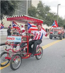  ?? CHASITY MAYNARD/ORLANDO SENTINEL ?? People attend the Florida Puerto Rican Parade.