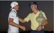  ?? WILFREDO LEE — THE ASSOCIATED PRESS ?? Justin Thomas, right, is congratula­ted by last year’s winner, Rickie Fowler, left, as he holds up his trophy after winning the Honda Classic golf tournament in a suddendeat­h playoff, Sunday in Palm Beach Gardens, Fla.