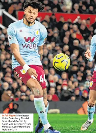  ??  ?? In full flight: Manchester United’s Anthony Martial has a shot deflected by Aston Villa defender Tyrone Mings as Conor Hourihane looks on