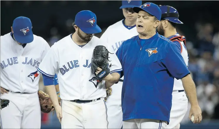  ?? — GETTY IMAGES ?? Blue Jays pitcher Drew Hutchison walks with manager John Gibbons Tuesday night at Rogers Centre in Toronto. The Blue Jays beat the Oakland A’s 4-2