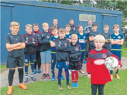  ?? Picture: Kim Cessford. ?? Some of the young Carnoustie players affected by the theft of their equipment with coaches, back from left, Simon Stott, Scott Arthur and Andy Millar at the changing rooms.