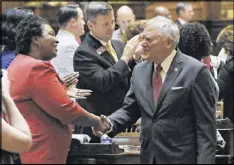  ?? BOB ANDRES /BANDRES@AJC.COM ?? Gov. Nathan Deal is greeted by House Minority Leader Stacey Abrams. Deal, making his annual Sine Die visit to the two chambers, praised lawmakers for at least trying to get along.