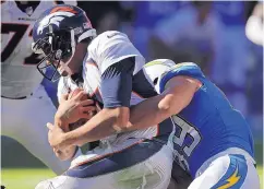  ?? JAE C. HONG/ASSOCIATED PRESS ?? Chargers defensive end Joey Bosa, right, sacks Denver quarterbac­k Trevor Siemian during the second half of Sunday’s game. Broncos coach Vance Joseph says benching Siemian is not the solution.