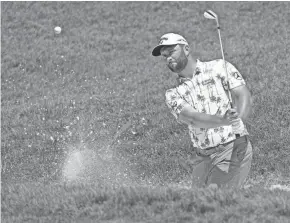  ?? ADAM CAIRNS/COLUMBUS DISPATCH ?? Jon Rahm hits out of a bunker on the 8th hole during a practice round of the Memorial Tournament at Muirfield Village Golf Club in Dublin on Tuesday.