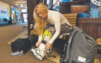  ?? Andy Cross, The Denver Post ?? Lindsey Vonn puts on her boots Wednesday inside Cooper Station in preparatio­n for downhill training at the U.S. Ski Team Speed Center at Copper Mountain.