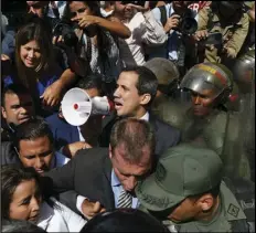  ?? ASSOCIATED PRESS ?? Opposition leader Juan Guaido yells into a megaphone for National Guards to let him and all opposition lawmakers into the National Assembly, outside the legislatur­e in Caracas, Venezuela, Tuesday.