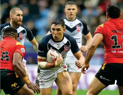  ?? GETTY IMAGES ?? Getting stuck in: Radley faces Papua New Guinea, with Tomkins in the background (left)