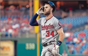  ?? CHRIS SZAGOLA/THE ASSOCIATED PRESS ?? Washington Nationals’ Bryce Harper looks on after striking out to end the first inning against the Philadelph­ia Phillies, Tuesday in Philadelph­ia.
