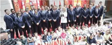  ??  ?? MADRID: Real Madrid team pose with the President of Madrid, Cristina Cifuentes at the Madrid Community headquarte­rs during the celebratio­ns after the team won the Spanish league football tournament. — AFP