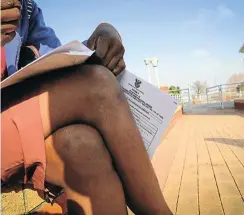  ?? Picture: Sebabatso Mosamo ?? A woman fills out an applicatio­n for a protection order at the Randburg magistrate’s court.