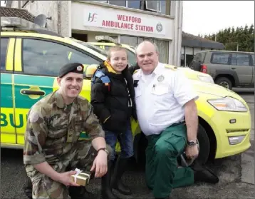  ??  ?? Logan with rescuers Cpl Stan Holloway and paramedic Declan Cunningham.